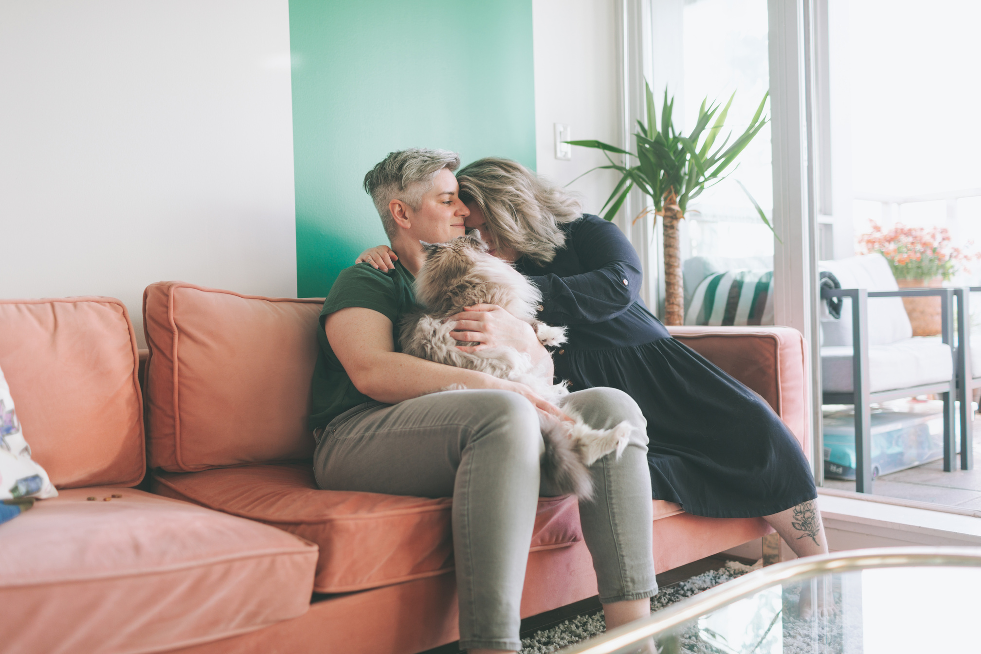 Female Couple with Their Pet Cat on the Sofa